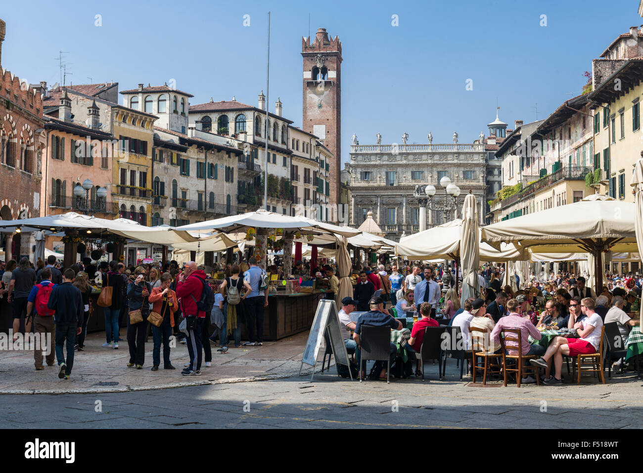 Market on Piazza Erbe, Torre dei Lamberti and the Casa dei Giudici (Judges' Hall) at the end of the square Stock Photo