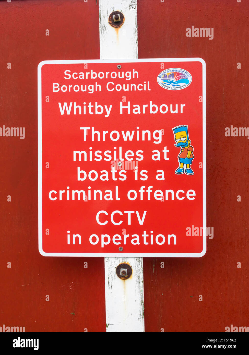 Scarborough Borough Council Warning Sign at Whitby Harbour Throwing Missiles at boats is a criminal offense CCTV in Operation Stock Photo