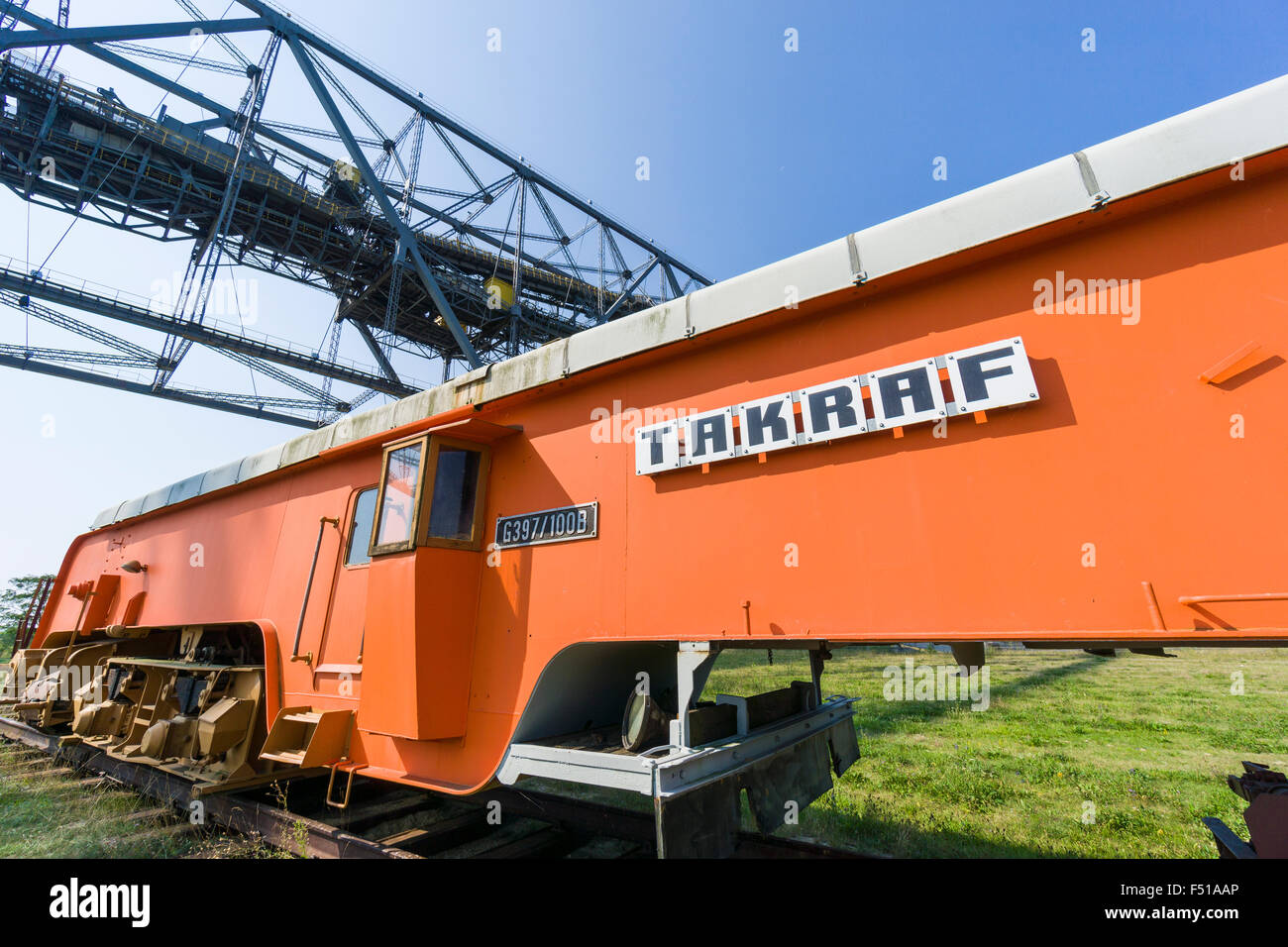 An orange Track Moving Machine of the company Takraf, used in brown coal opencast mining to shift railway tracks, a part of the Stock Photo