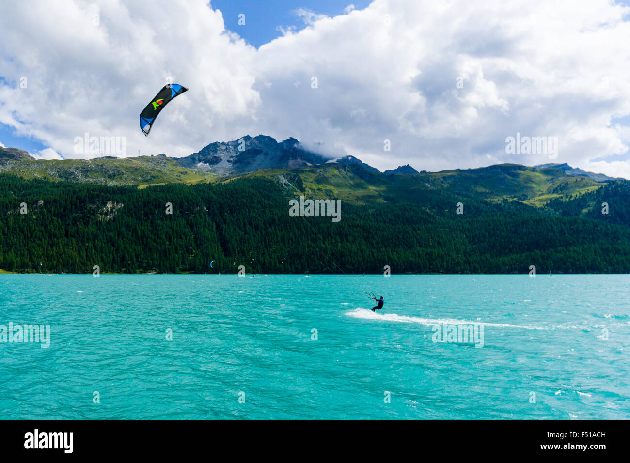 A Kite Surfer is crossing the Lej da Silvaplana, a high altitude lake near St. Moritz Stock Photo