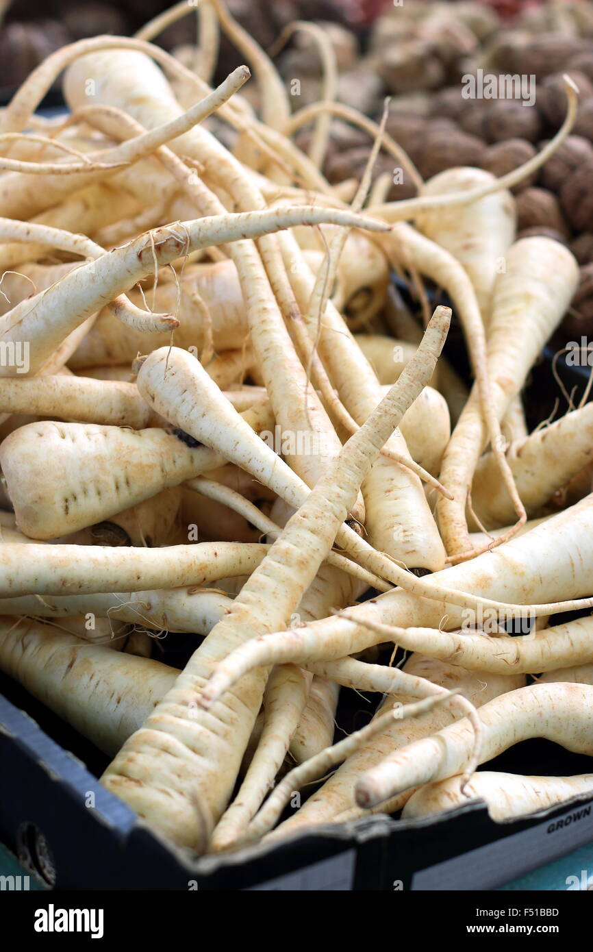 Fresh parsnip being sold at market Stock Photo