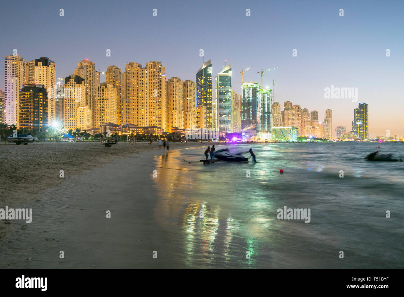 Night view of beach and skyline of high-rise apartment blocks at JBR Jumeirah Beach Residences in Dubai UAE Stock Photo