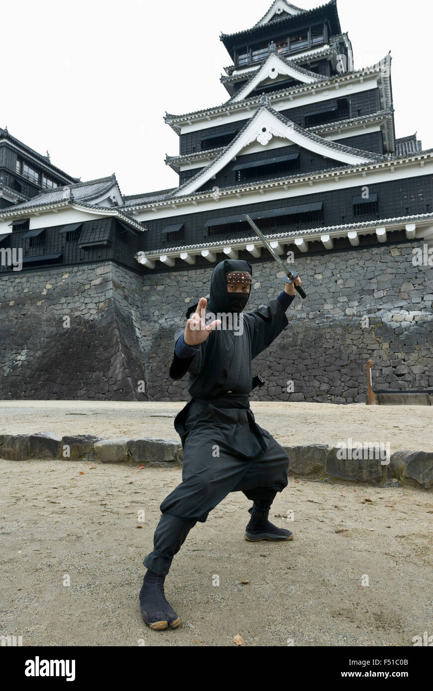 Ninja warrior posing in front of famous Kumamoto Castle in Kyushu Japan Stock Photo