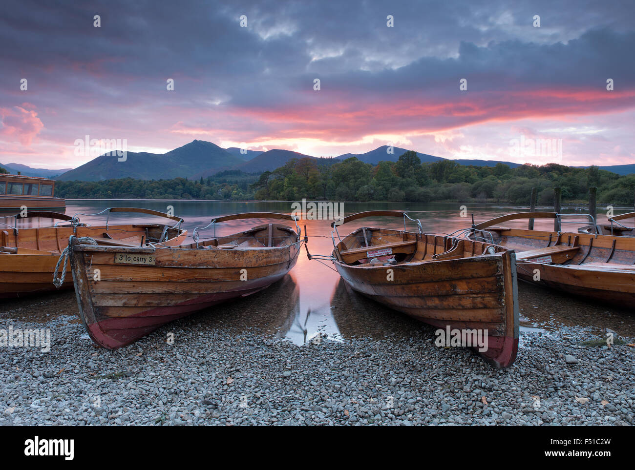 Rowing boats on the shore of Derwent Water near Keswick at sunset, Lake District, Cumbria, England, Uk, Gb Stock Photo