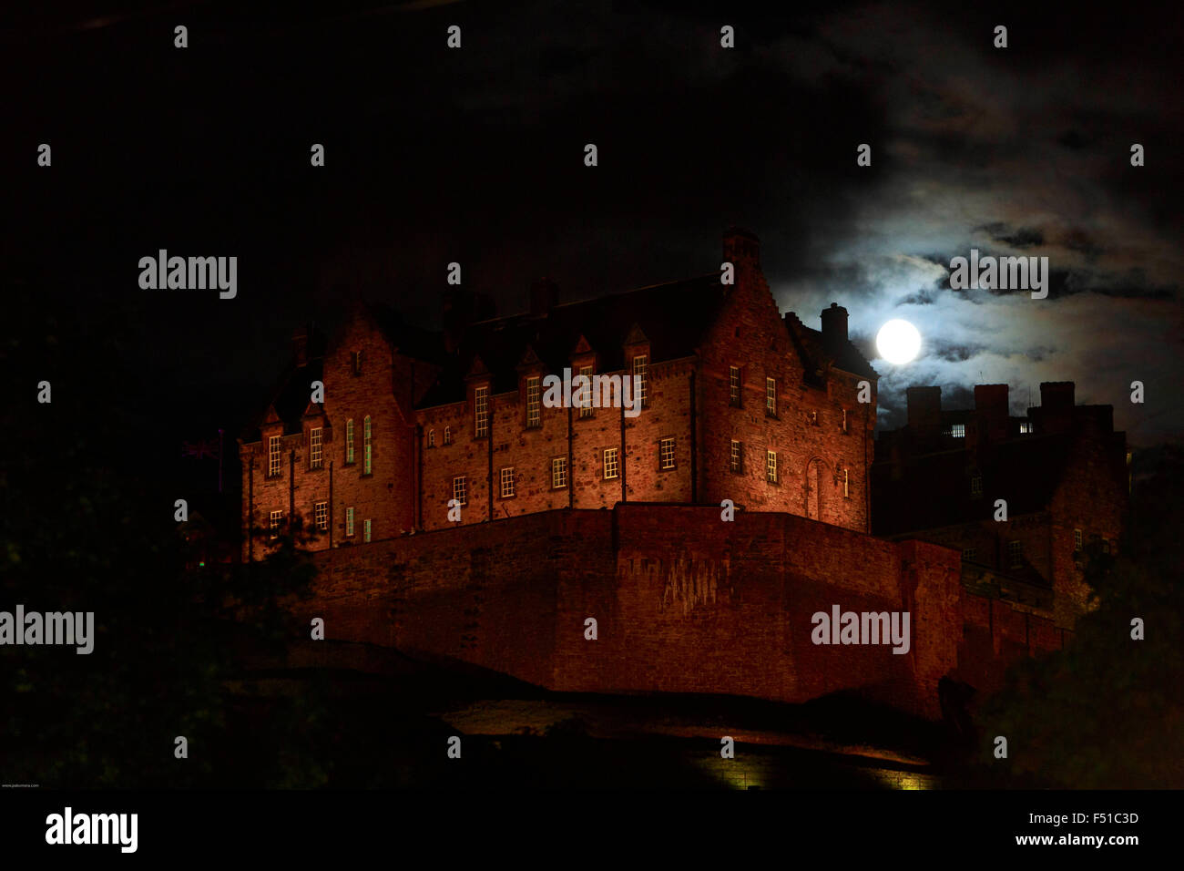 Full moon in Edinburgh during August. August Edinburgh Full moon over the Edinburgh Castle. Stock Photo