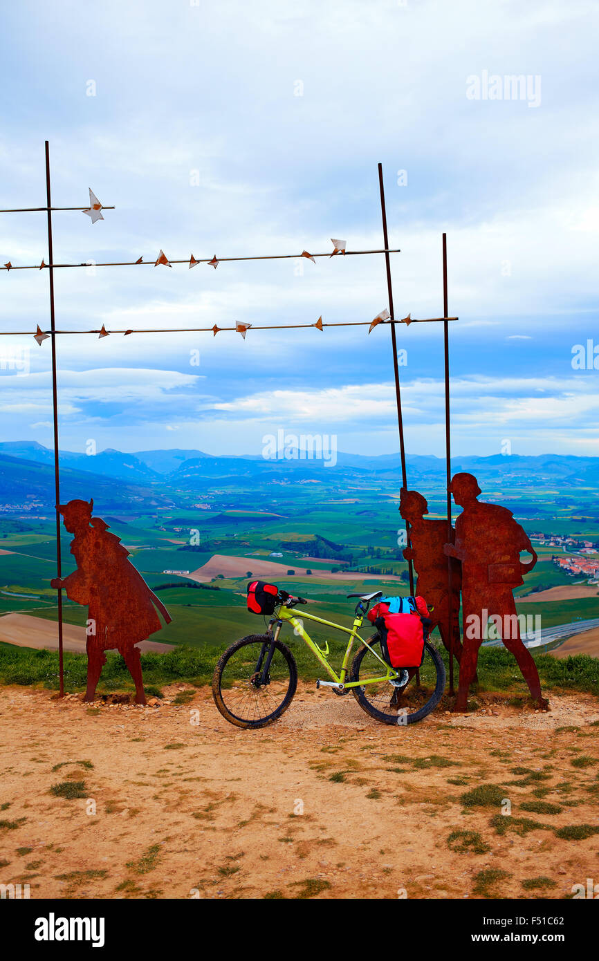 The way of Saint James Alto del Perdon top with steel sculpture of pilgrims at Navarra and bike Stock Photo