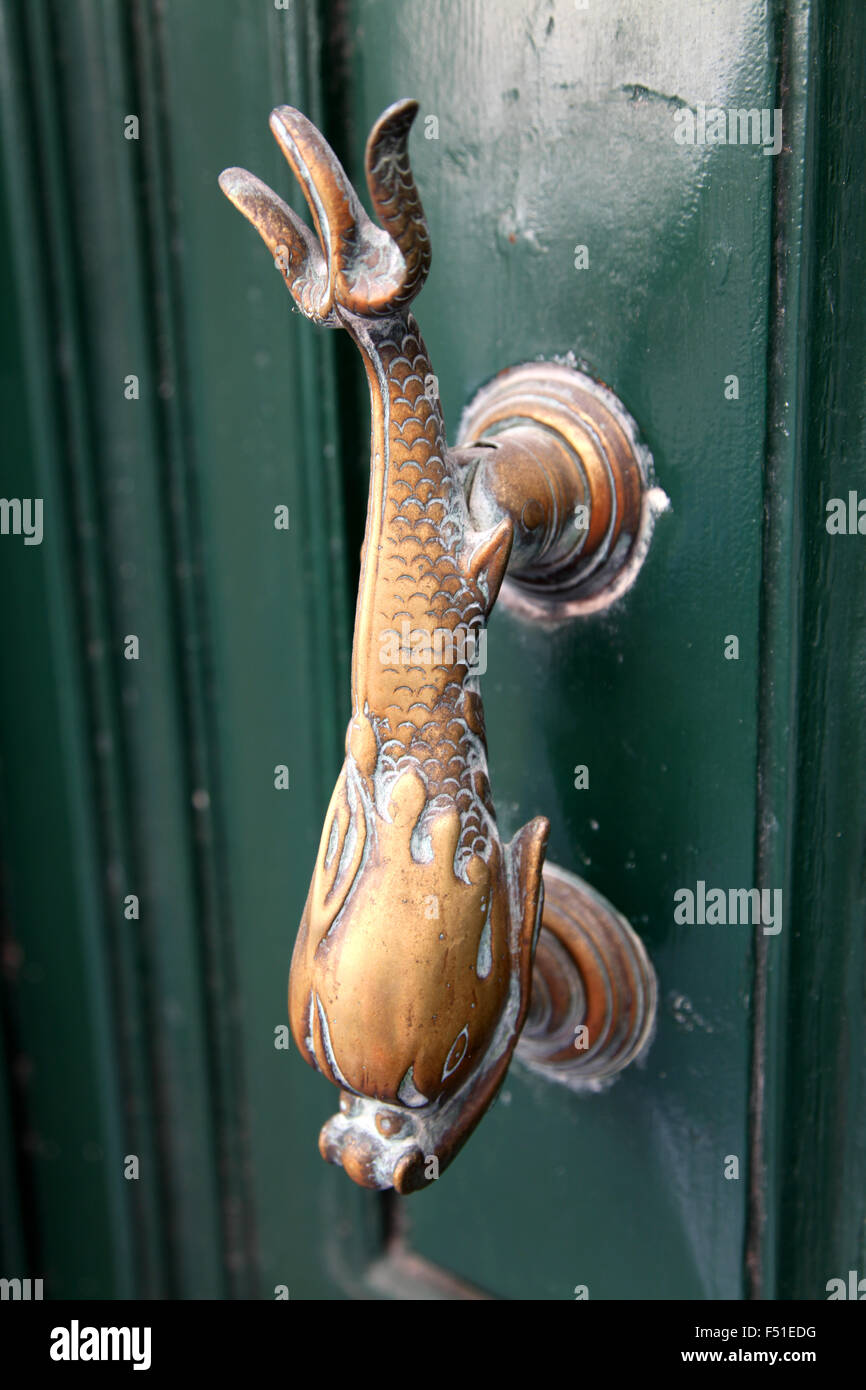 The traditional Maltese door furniture is the Brass Dolphin Stock Photo