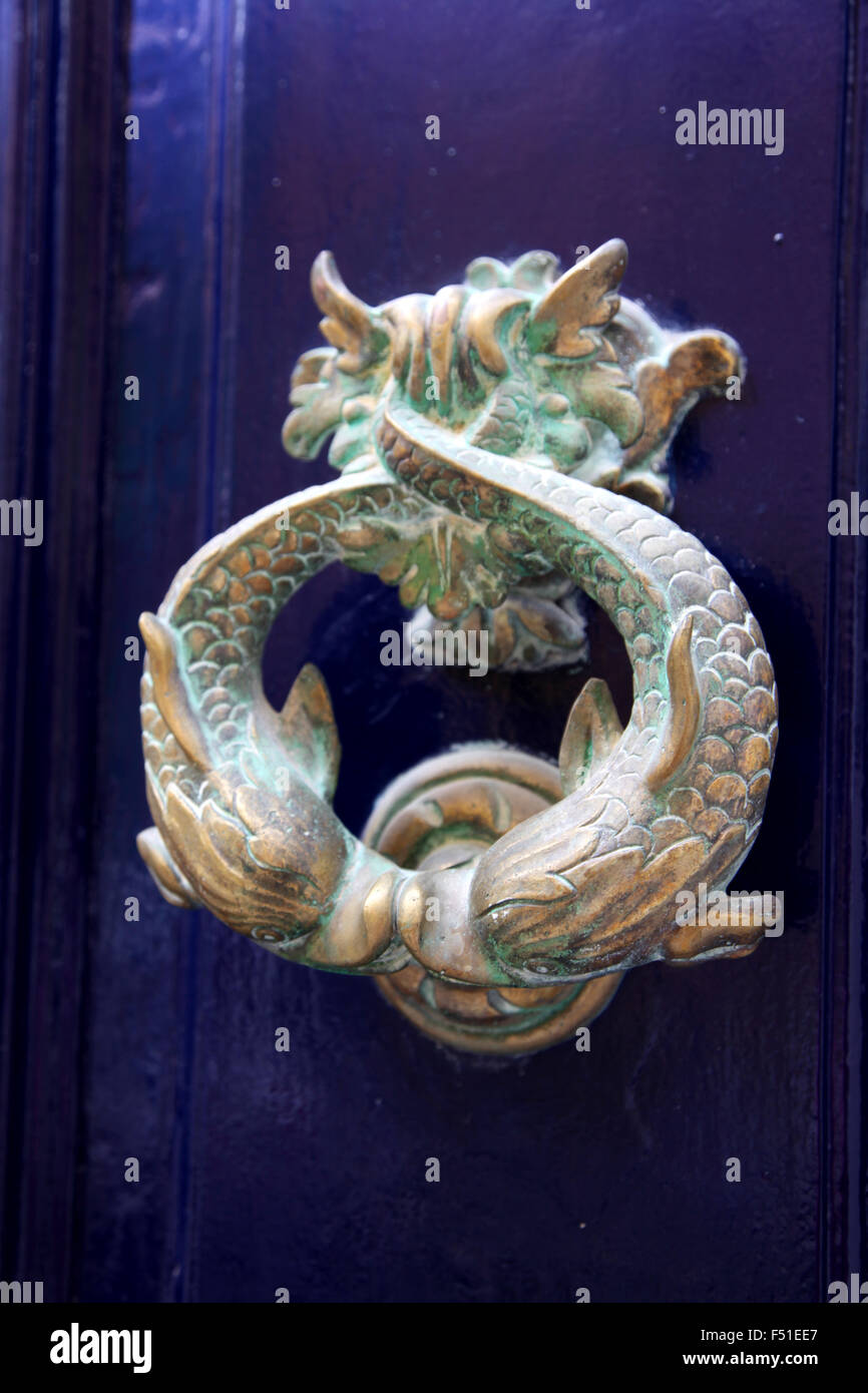 The traditional Brass Maltese Door knocker features a dolphin or in this case a pair of kissing Dolphins Stock Photo