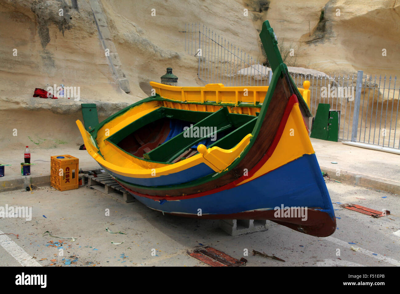 A colourful Maltese traditional fishing boat the Luzzu being repainted in Birgu, Grand Harbour, Malta Stock Photo