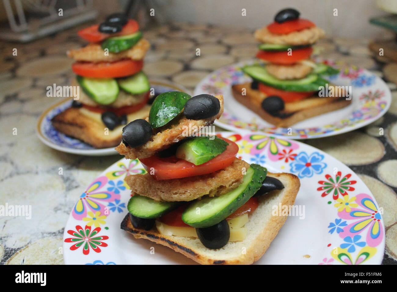 appetizing vegetarian sandwich from soy,ripe green  cucumber, olive, pulp tomato on crust wheat toasts Stock Photo