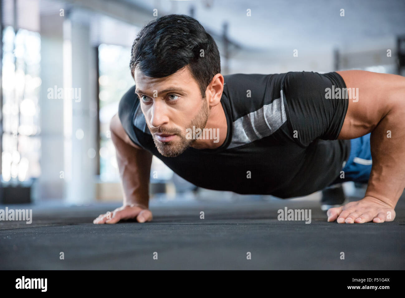 Portrait of a fitness man doing push ups in gym Stock Photo - Alamy