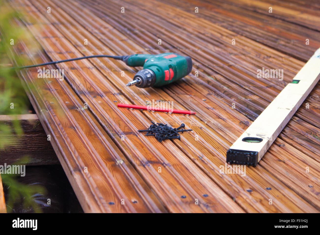 A handyman is building a terrace, in the garden Stock Photo Alamy