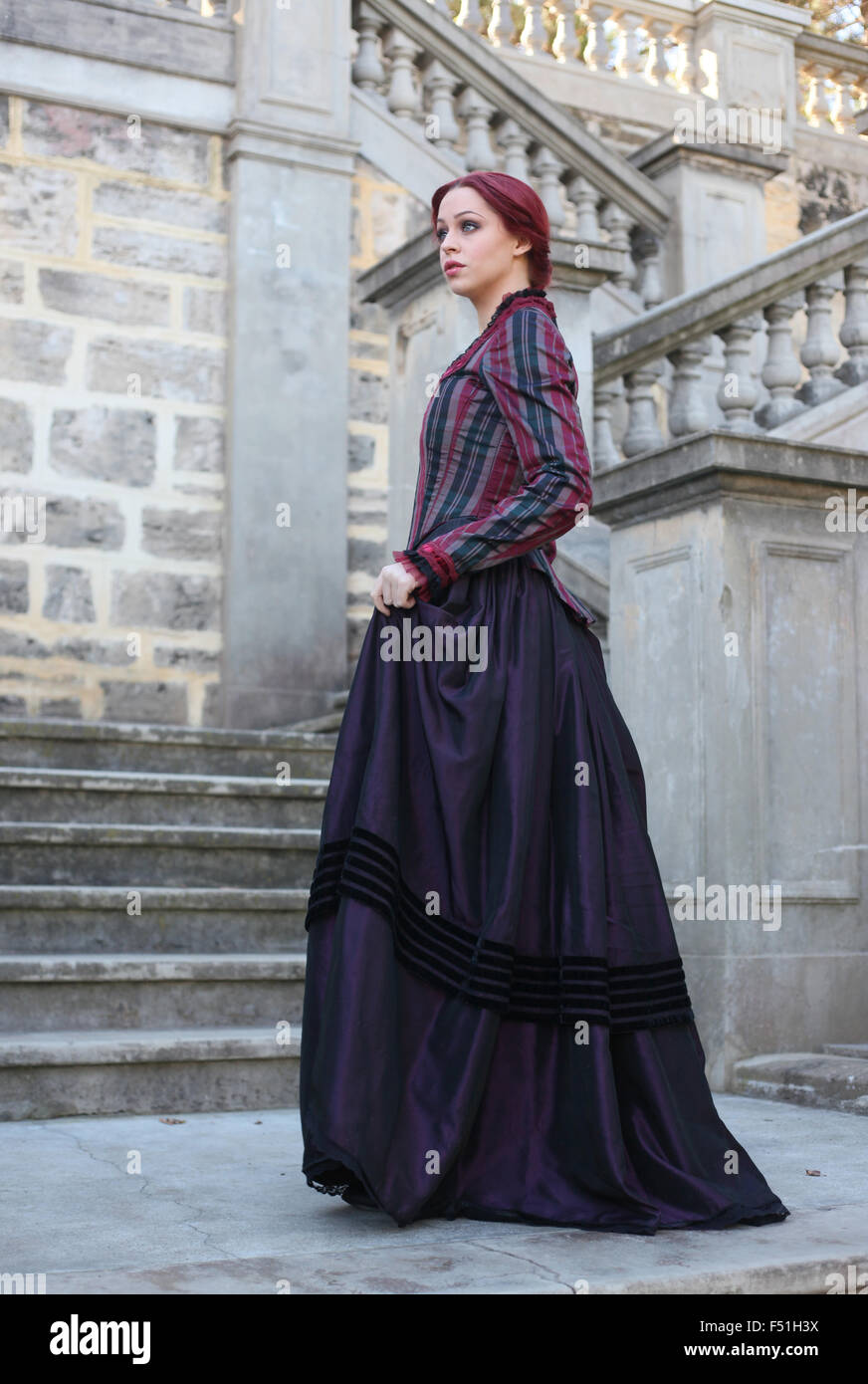 Portrait of a beautiful red haired girl wearing  Gothic inspired Victorian era clothes. Stock Photo