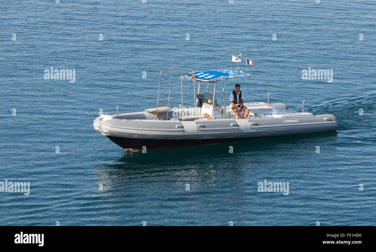 Ajaccio, France - June 30, 2015: Small pilot boat with man on board goes on sea water in port of Ajaccio, Corsica island Stock Photo