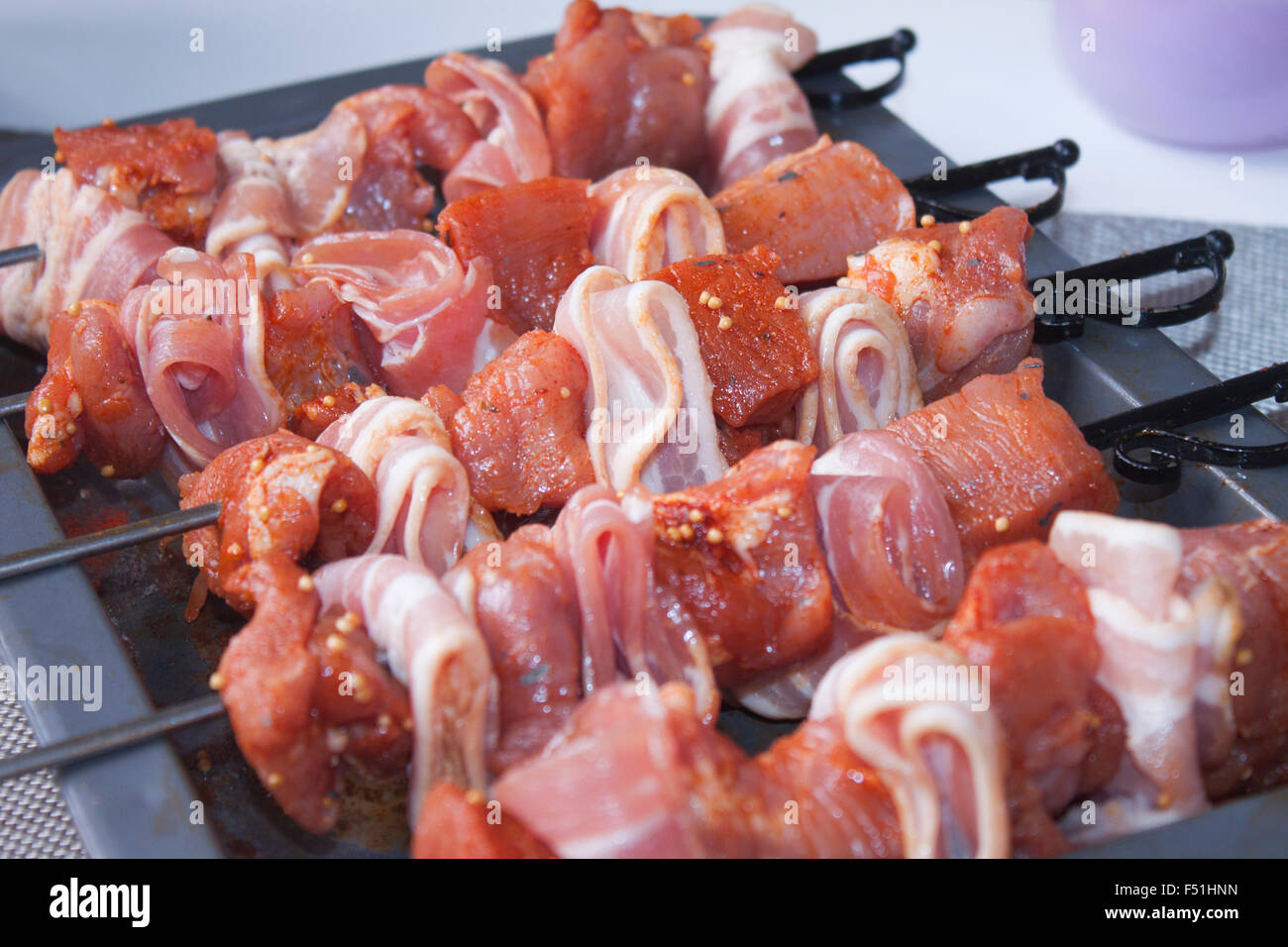 A pile of pork skewers, with bacon and marinated pork Stock Photo Alamy
