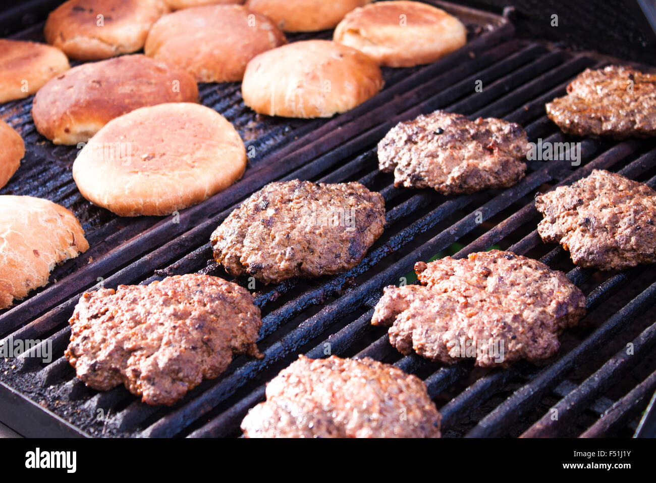 Grilling hamburger beef and bun, on a barbeque Stock Photo Alamy