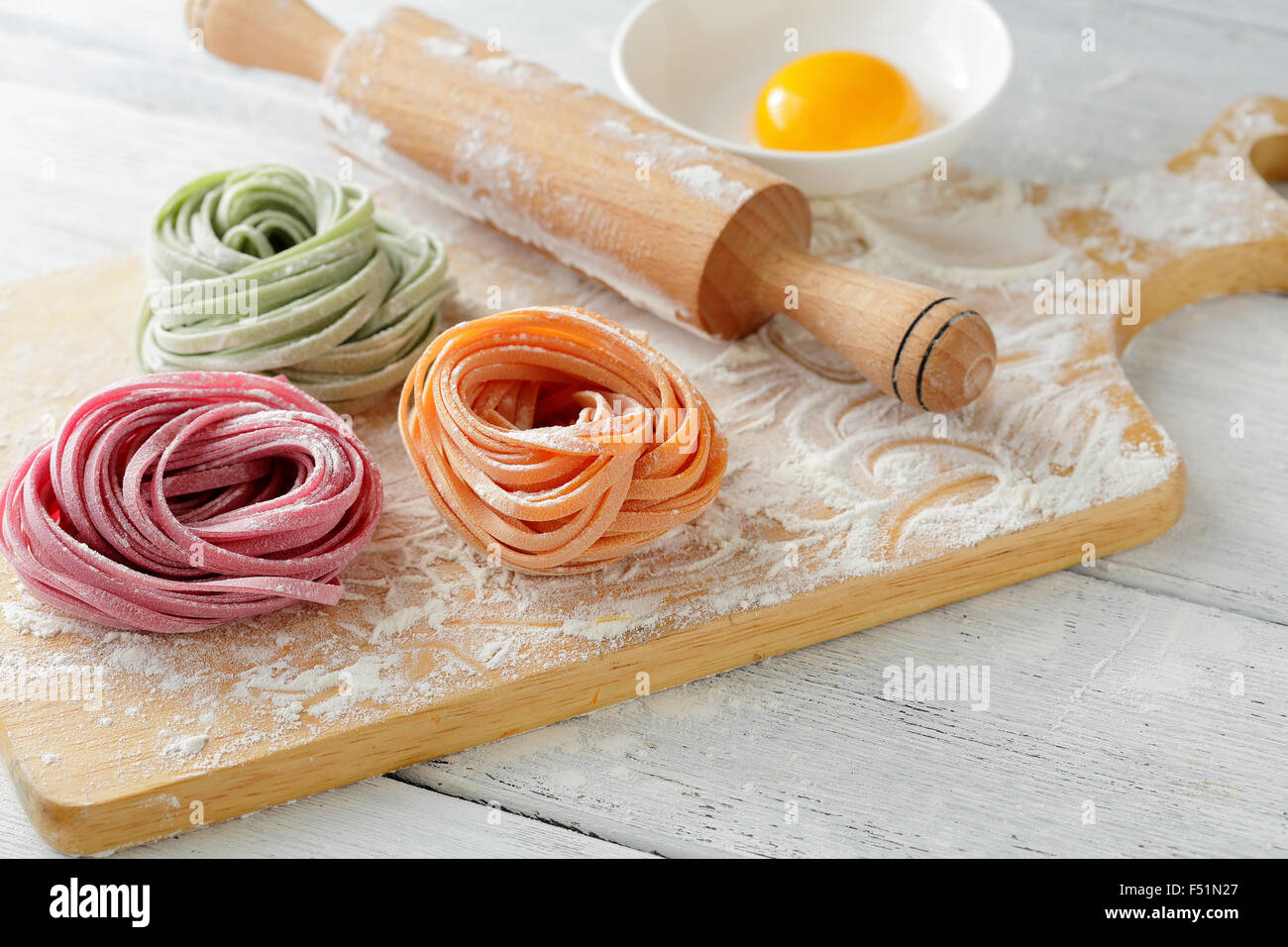 color pasta on board and rolling pin, food closeup Stock Photo Alamy