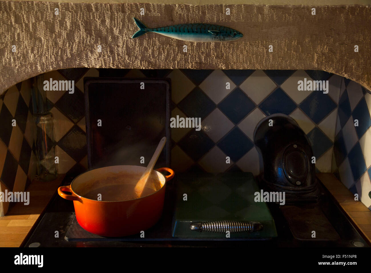 Food cooking in a cast iron casserole pan, on and old fashioned range cooker. Country kitchen in Yorkshire, England, UK. Stock Photo