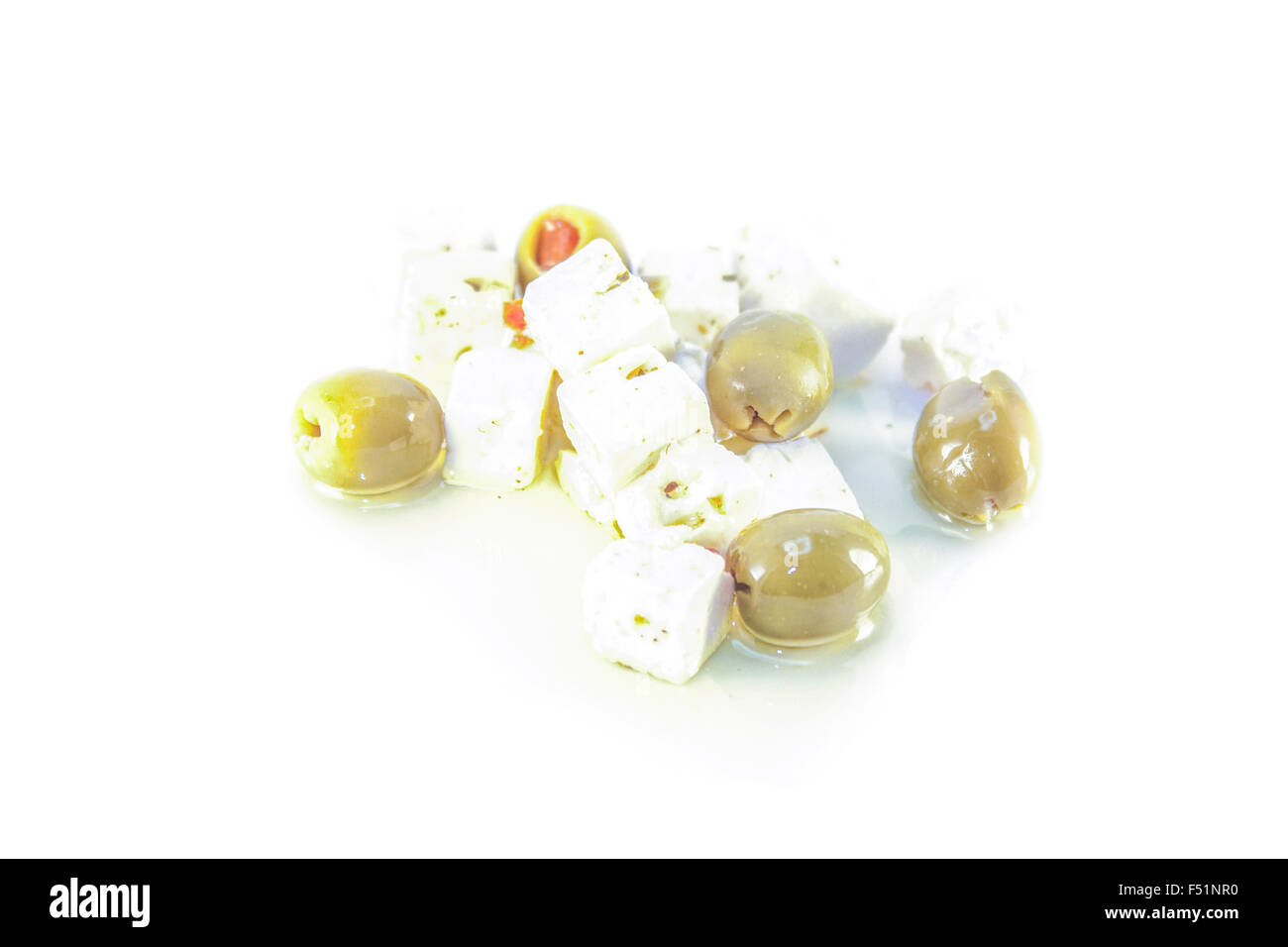 White feta cheese and green olives, isolated on white background Stock Photo