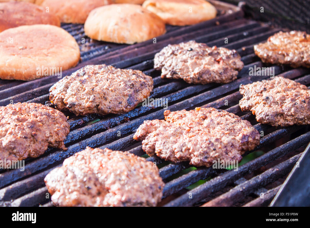 Grilling hamburger beefs and buns, on a gas barbeque Stock Photo