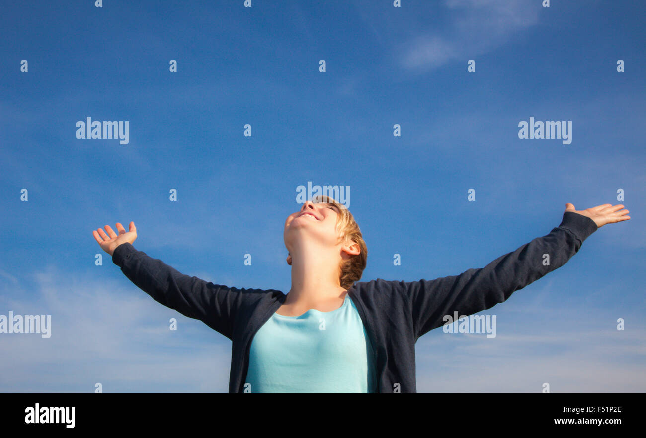 Attractive teenage girl with arms wide open Stock Photo