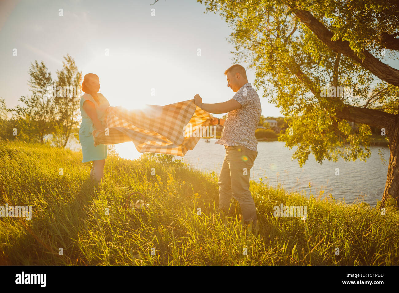 Romantic couple put a blanket on background summer lake Stock Photo Alamy
