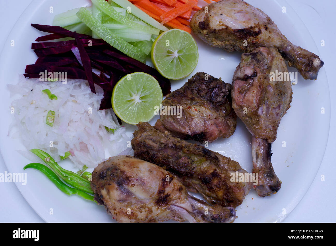 Roasted chicken with fresh salad served in a plate in Chennai, Tamil Nadu, India, Asia Stock Photo