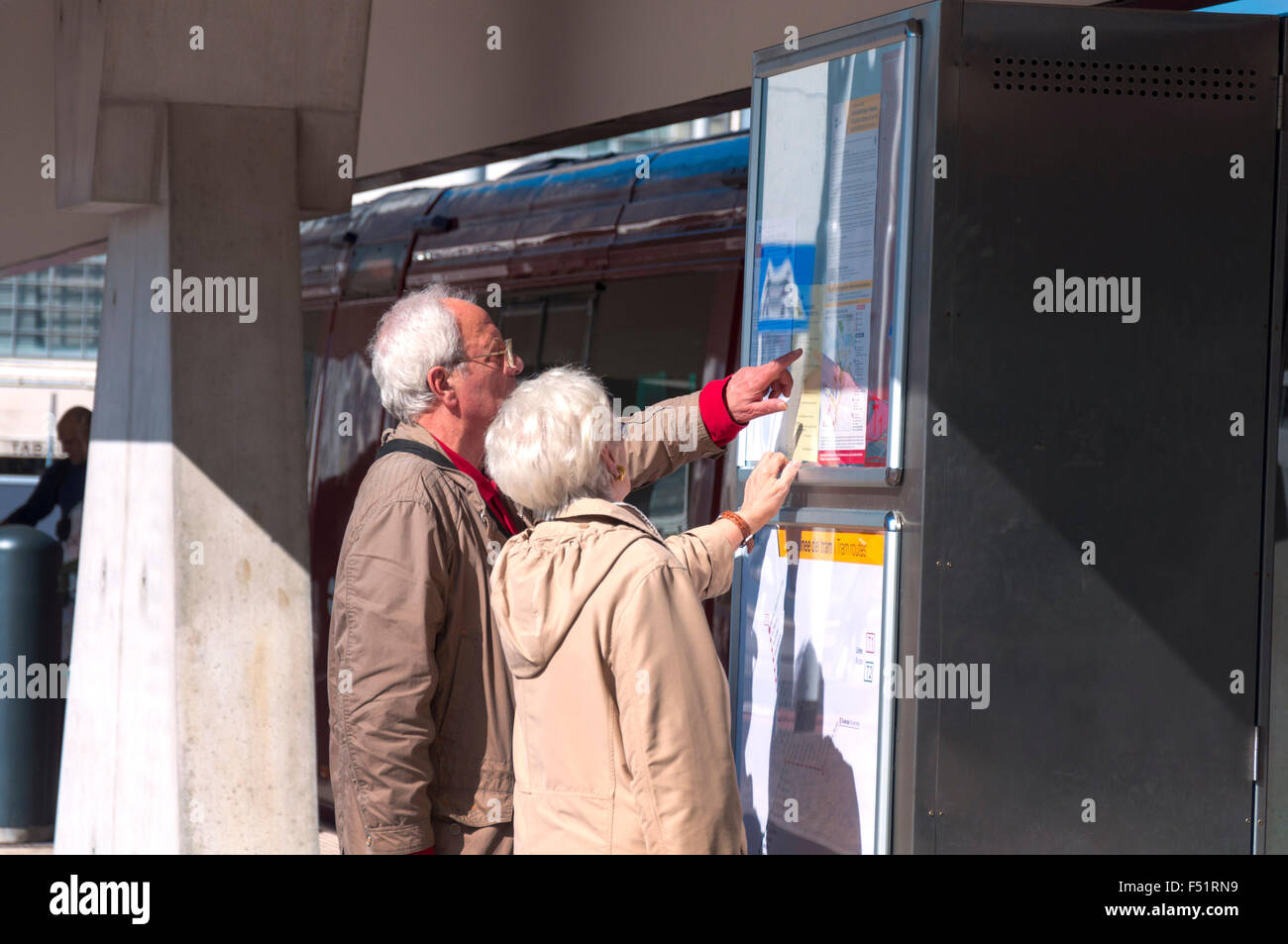 Elderly senior couple consult timetable for Actv tram in piazzale Roma, Venice, Italy Stock Photo