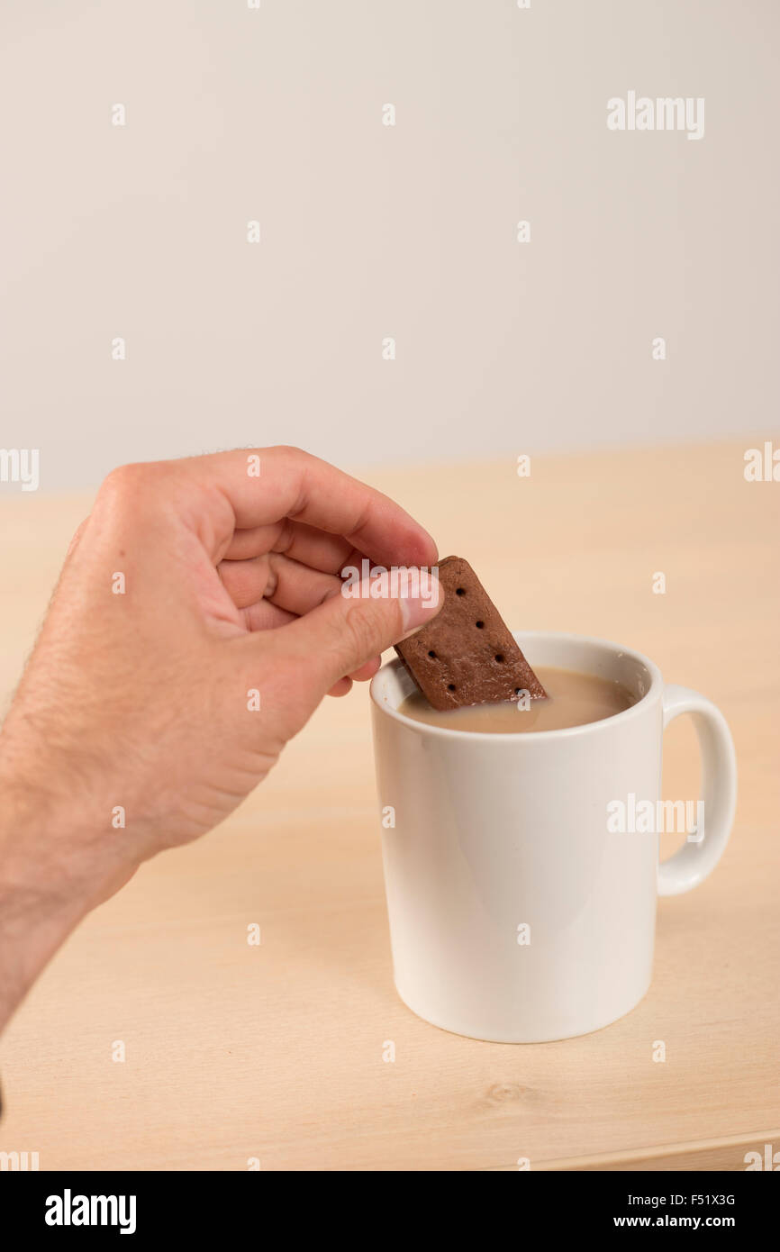 dunking biscuit in tea Stock Photo Alamy
