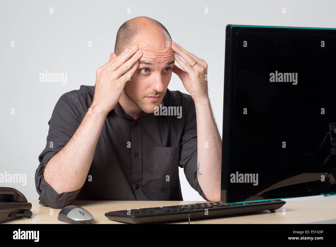 Looking at screen in disbelief Stock Photo