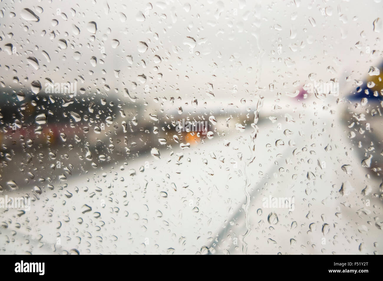 Rain drops on airplane window, Ryanair aircrafts, Eindhoven airport, Netherlands. Stock Photo