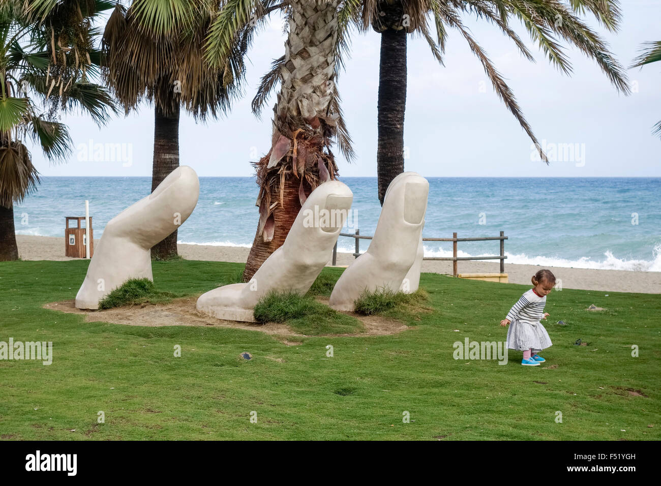 Statue caring open hand around palm tree, mediterranean beach, Andalusia, Fuengirola, Southern Spain. Stock Photo