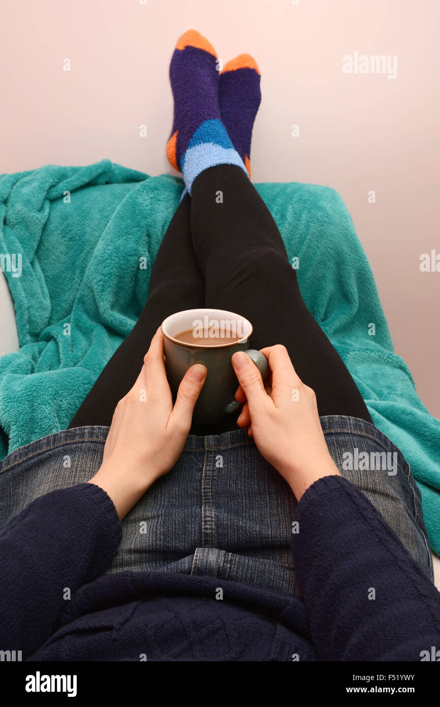 Woman lying on couch with blanket hi-res stock photography and images ...