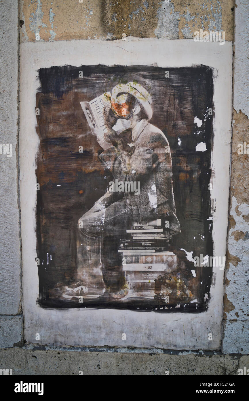 street art of a man reading a book Stock Photo