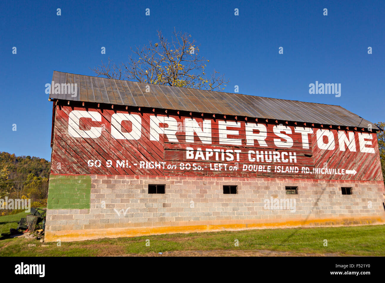 An old wooden barn with a painted advertisement along the Quilt Trails in Prices Creek, North Carolina. The quilt trails honor handmade quilt designs of the rural Appalachian region. Stock Photo