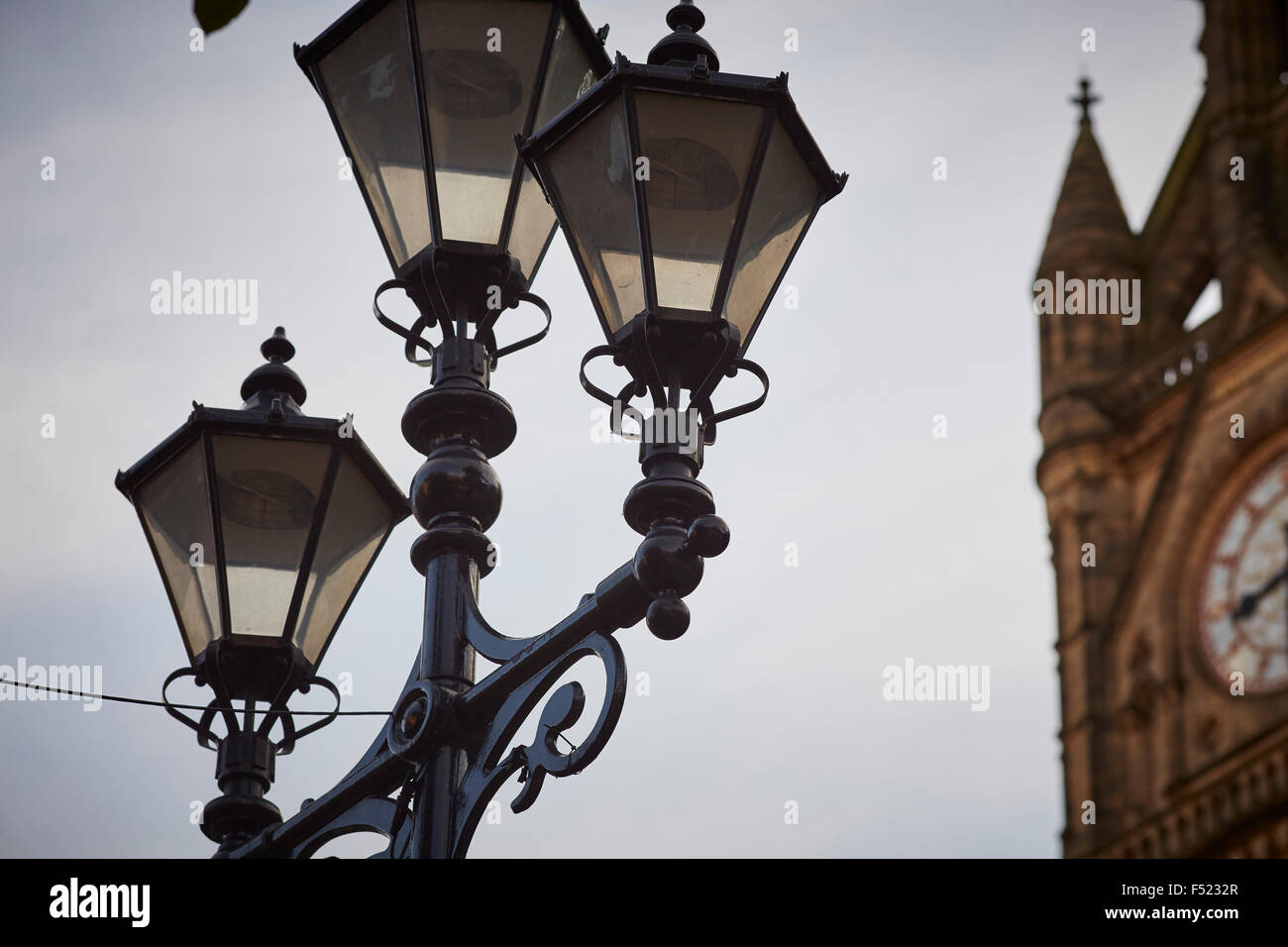Manchester Town Hall  clock face close up showing the victorian street lamps lights in Albert Square ornate    Manchester Town H Stock Photo