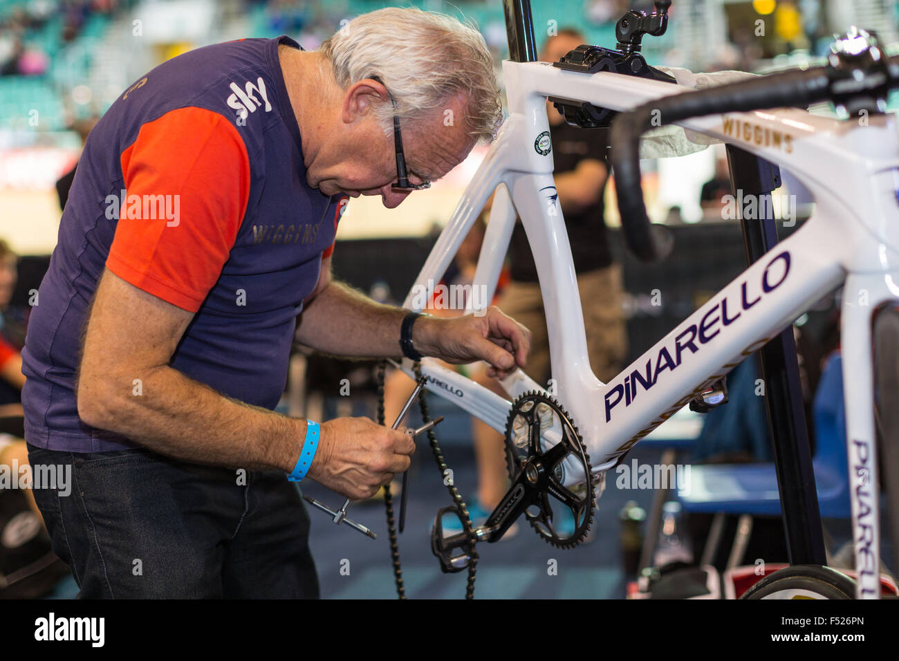 A mechanic works on a Team Wiggins bicycle during the Revolution cycling competition at The National Cycling Centre Manchester Stock Photo