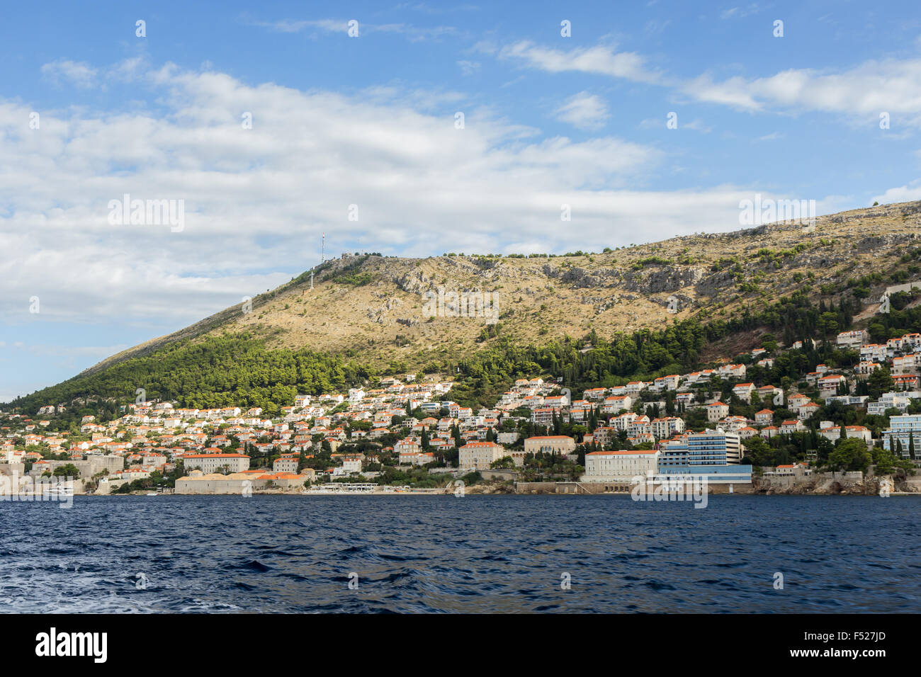 View of buildings on the hillside and Mount Srd from the sea in Dubrovnik, Croatia. Copy space. Stock Photo