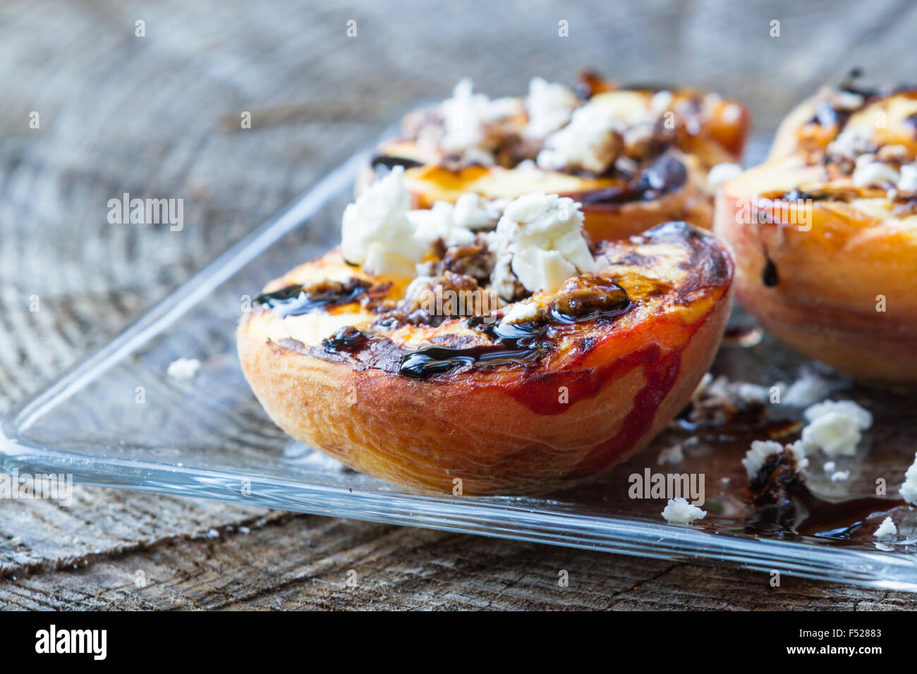 grilled, peaches with a balsamic reduction and goat cheese Stock Photo