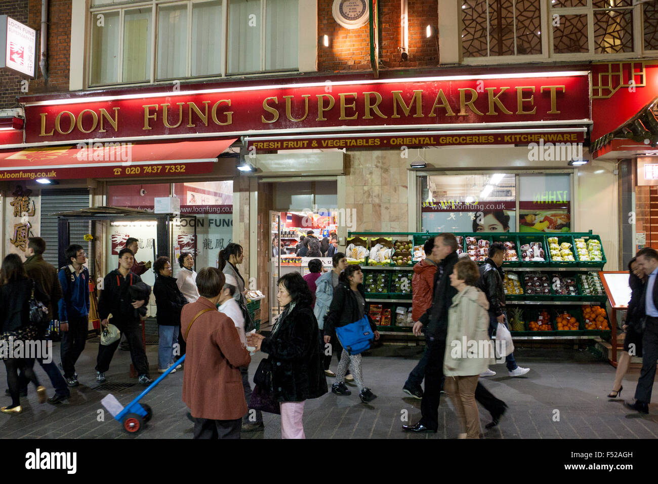 Busy street scene outside Loon Fung supermarket on Gerrard Street in Chinatown West End London England UK Stock Photo