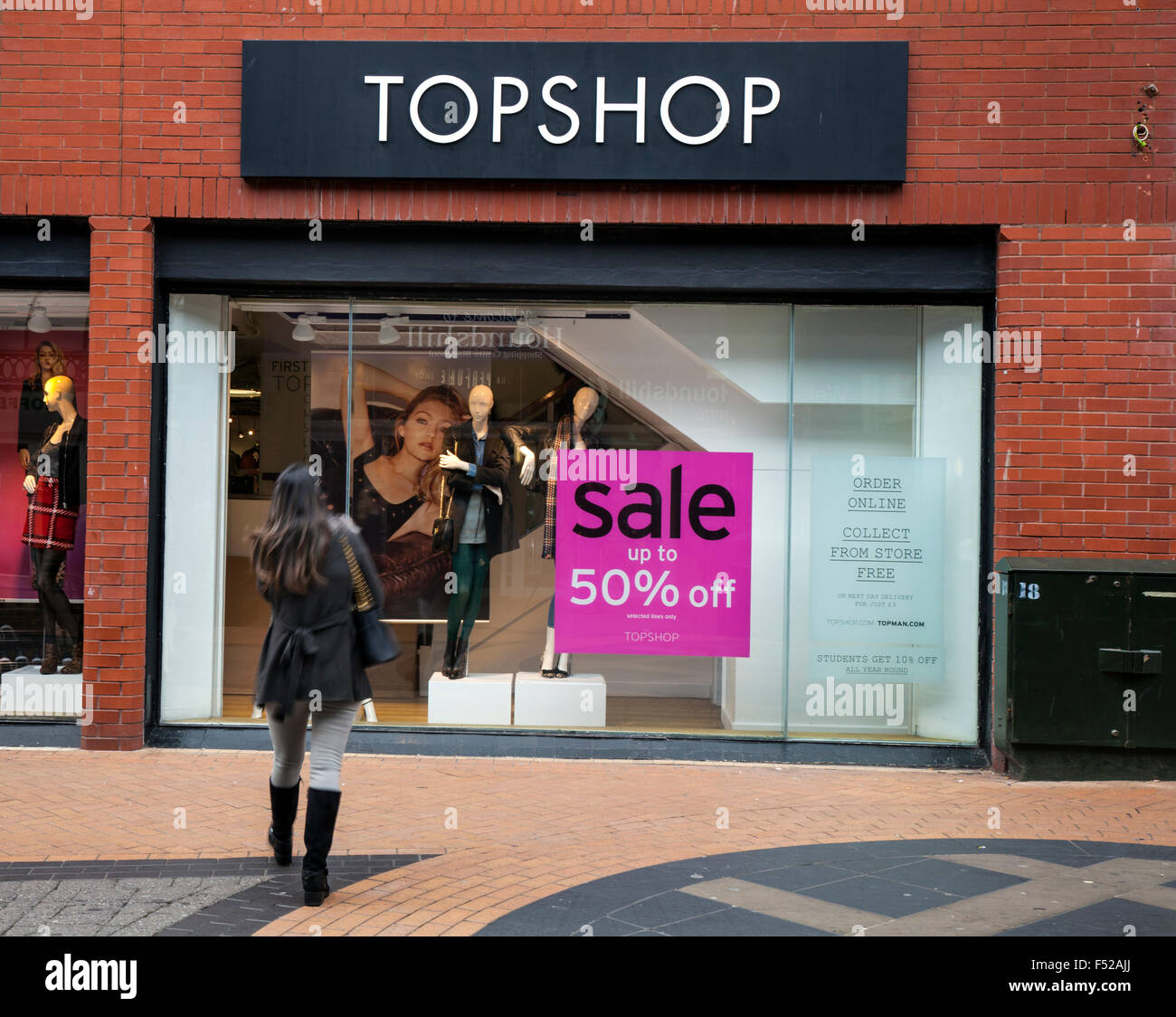 Shopper outside Topshop Sale poster 50% off, in Victoria Street, Blackpool,  Lancashire, UK Stock Photo - Alamy
