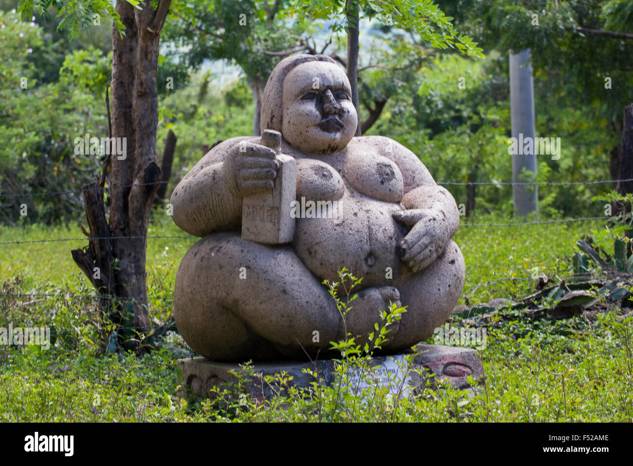 Stone sculpture representing a fat woman placed on 'la ruta del cafe' (the coffee route') in the mountains surrounding Esteli Stock Photo