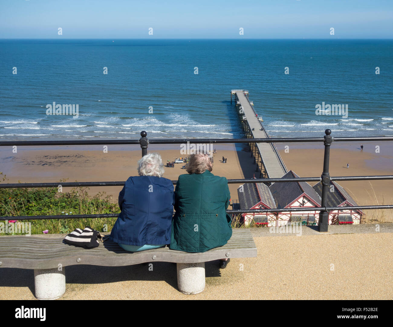 Elderly people sitting on seat overlooking the sea at Saltburn, North Yorkshire, England. UK Stock Photo