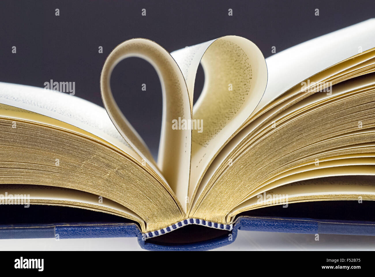 Open book, two pages folded into the shape of a heart Stock Photo