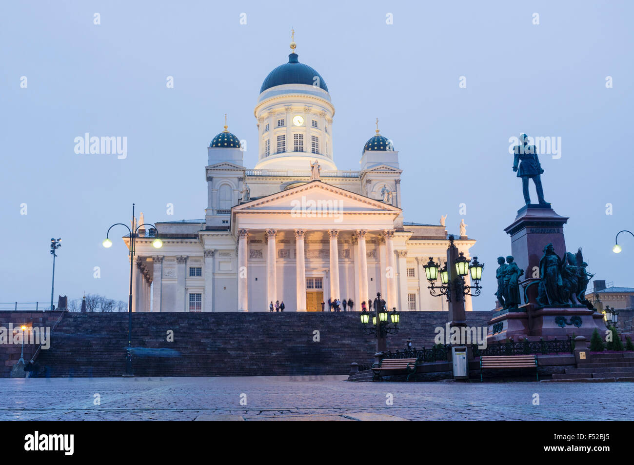 Lighted Lutheran Cathedral and statue of Tsar Alexander II at dusk. Senate square, Helsinki, Finland Stock Photo