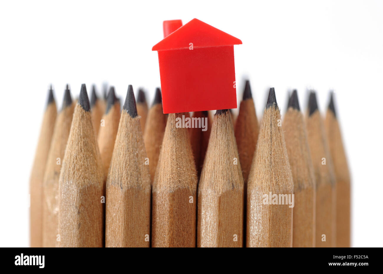 MODEL HOUSE ON PENCILS RE MORTGAGES FIRST TIME BUYERS HOME HOMES INCOMES HOUSEHOLD BUDGETS WAGES HOUSING MARKET LOAN INTEREST UK Stock Photo