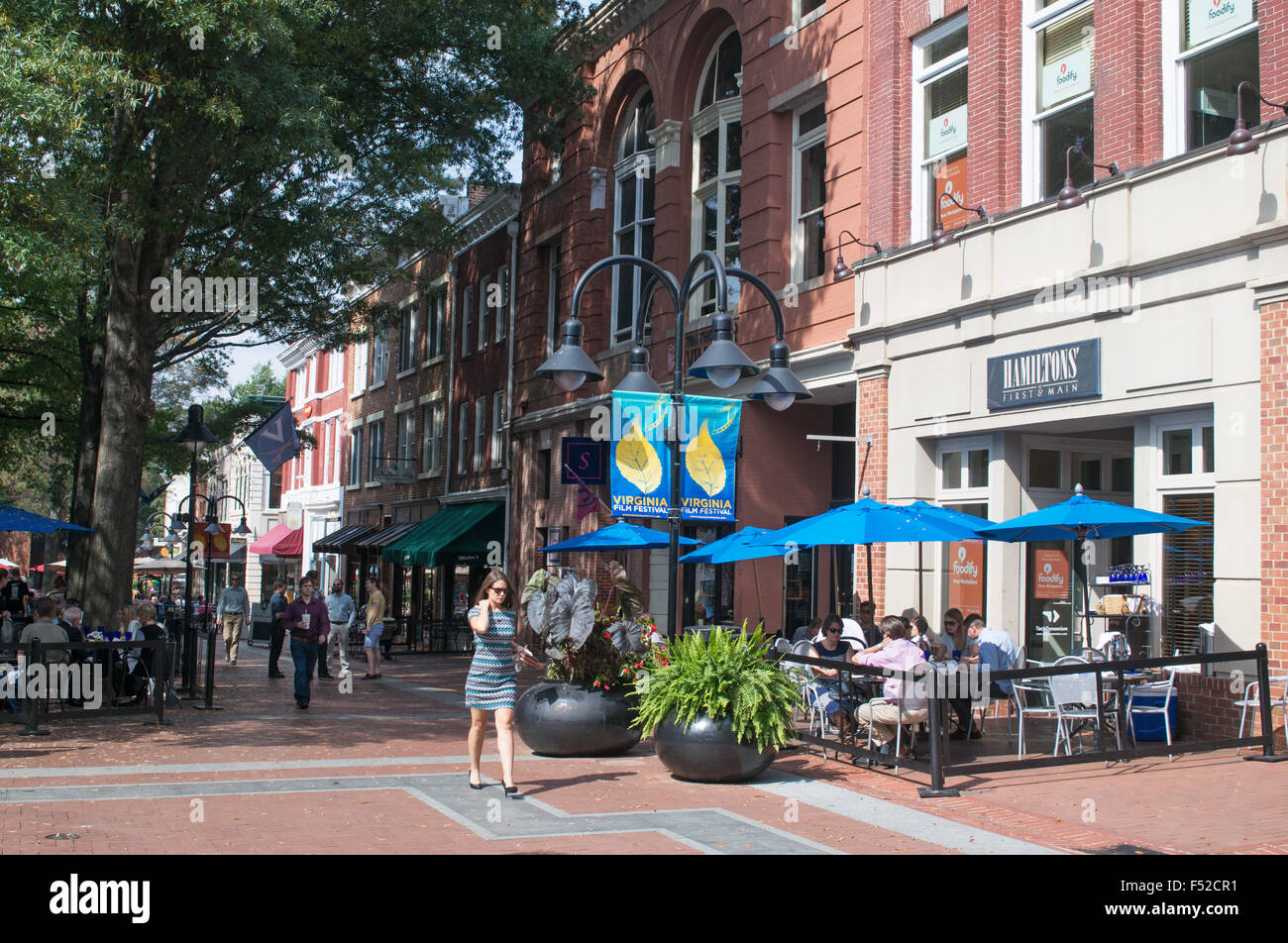 Woman walking past diners Charlottesville Main Street, Virginia, USA Stock Photo
