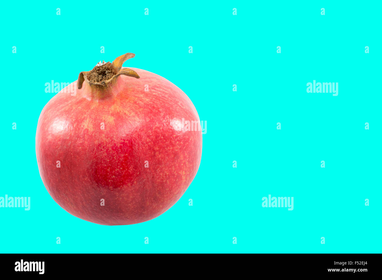 Juicy pomegranate on composite colored background Stock Photo