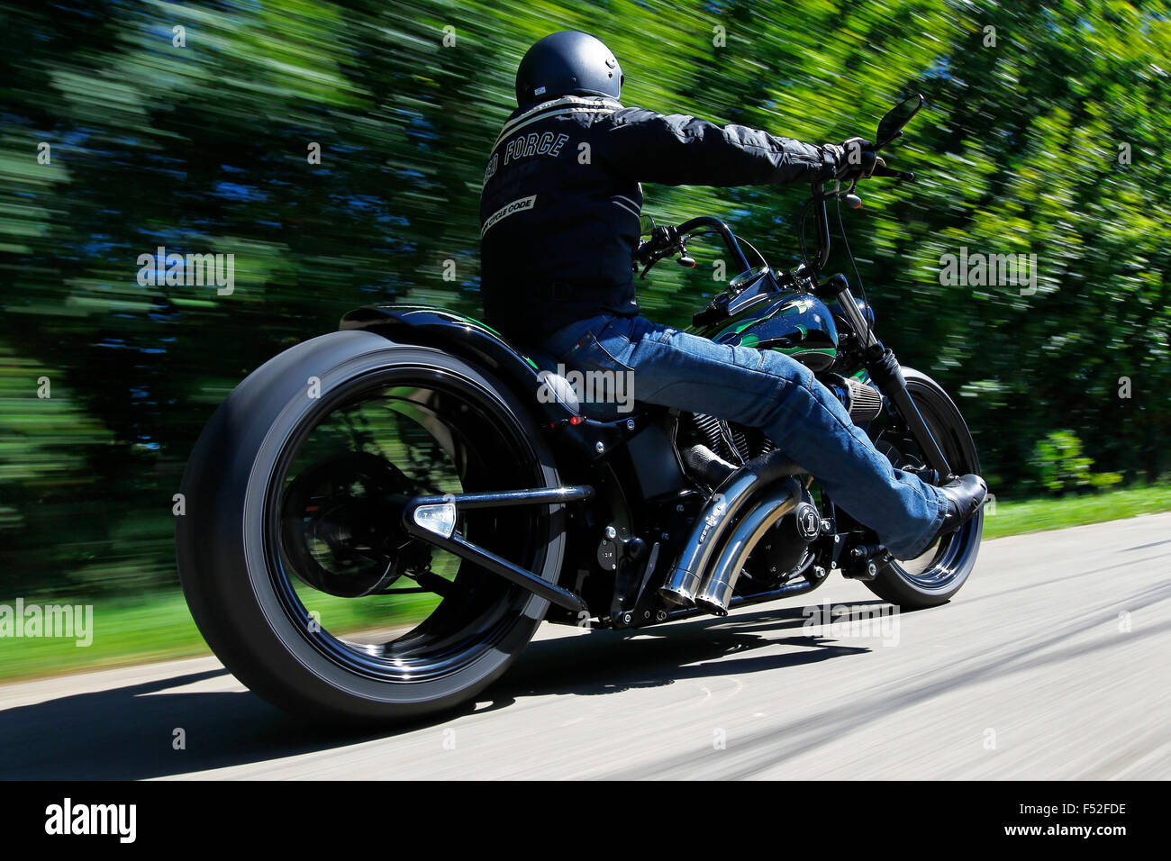 Motorcycle, mood bike, chopper, country road, trees, Custom bike on Harley Basis, year of construction in 2011, extremely wide rear tire, Stock Photo