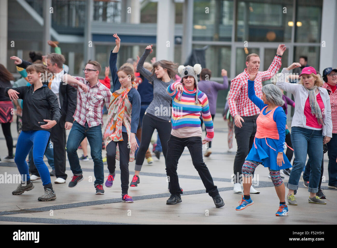 Many people dance in the  Queen Elizabeth Theatre square in downtown of Vancouver BC Stock Photo